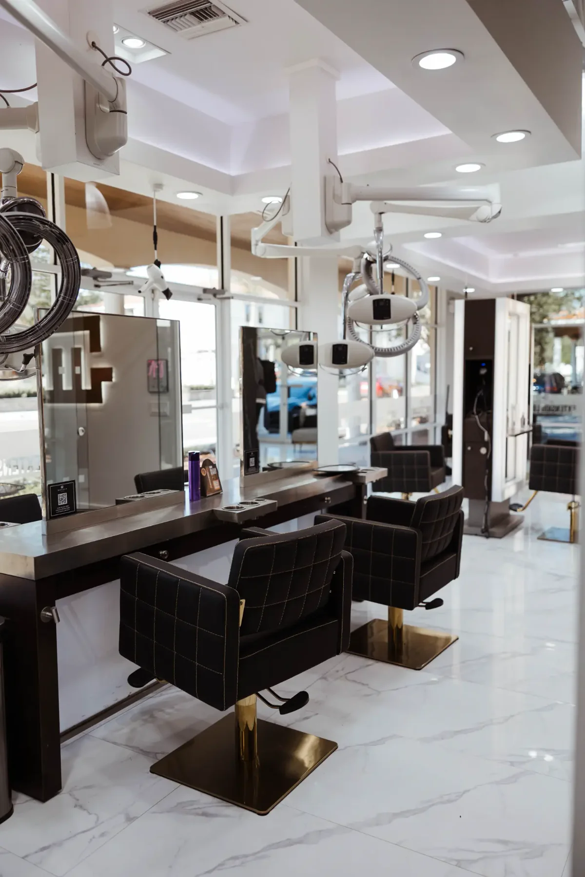Monaco Extension Lounge styling stations &mdash; close view of gold-base chairs and processing equipment
