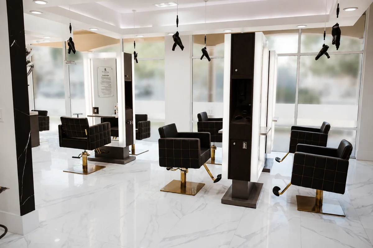 Monaco Extension Lounge South Tampa &mdash; gold-base styling chairs, marble floors, Bay to Bay location