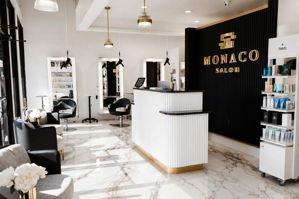 Monaco Salon Dale Mabry interior &mdash; marble floors, gold reception desk, South Tampa hair salon