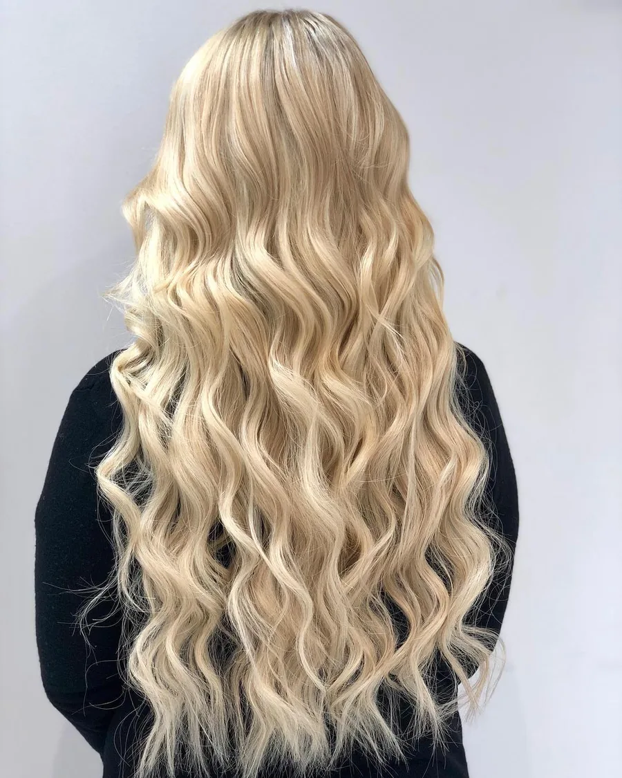 Platinum blonde wavy hair extensions &mdash; genius weft installation at Monaco Salon South Tampa