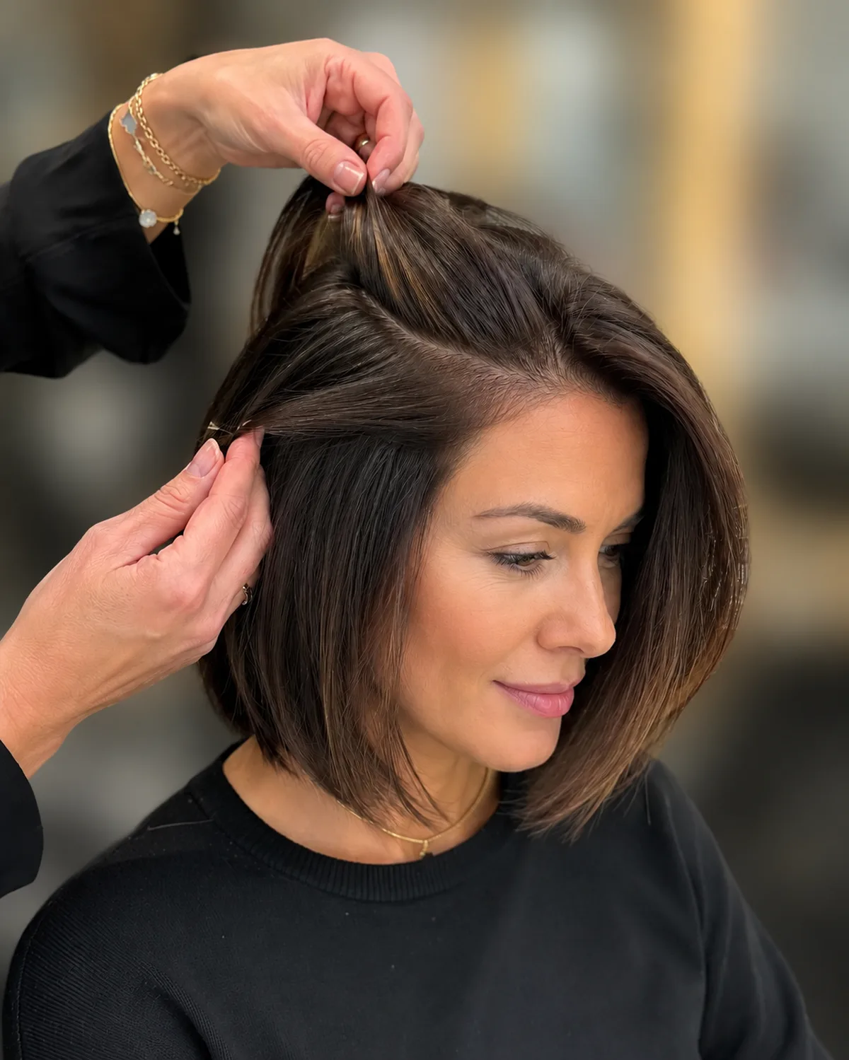 V-Light UV extensions for short hair at Monaco Salon Tampa &mdash; stylist installing extensions on bob-length hair